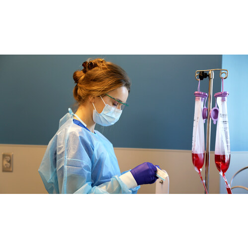 Nursing student preparing IV bags in the simulation lab