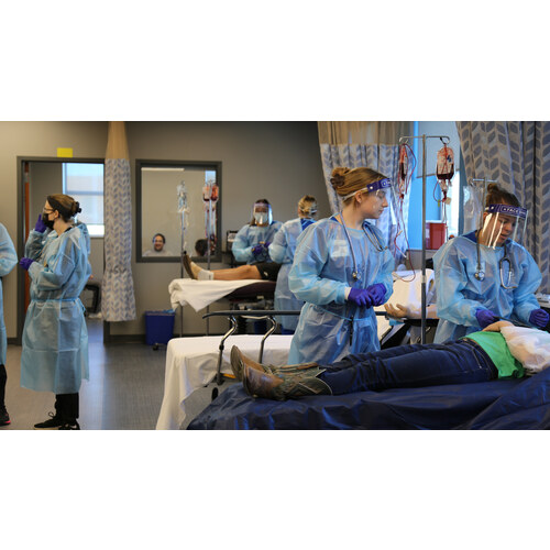 Nursing students in gowns during a mass-casualty simulation